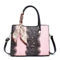 Detail of pink crocodile pattern tote with silk scarf handle and gold hardware - Pink