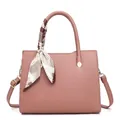 Detail of dusty pink pebbled leather handbag with silk scarf wrap and golden rivets - Pink
