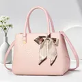 Elegant pink crocodile embossed handbag with decorative silk scarf and shoulder strap - Pink