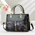 Detail of crocodile pattern leather and vintage floral embossing on women handbag - Printed Purple
