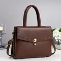 Deep brown textured faux leather handbag with gold twist lock for daily commute fashion - Pink