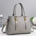 Elegant grey embossed handbag with gold hardware and detachable shoulder strap for women - Gray