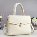 Detail of cream crossbody bag featuring lychee texture and gold metal twist lock - Off White