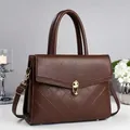 Dark brown leather crossbody bag with quilted panel and golden twist lock closure - Coffee