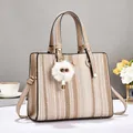 Minimalist straw woven tote bag with brown leather straps and plush charm for summer commute - Khaki