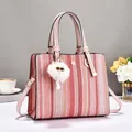 Fashionable woven striped tote bag with pink leather handles and cute plush charm - Pink
