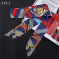 Detail of a silk scarf with equestrian horse stirrup patterns on a deep blue background - Blue Red Gold Print (C22-2)
