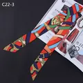 Macro detail of a vintage equestrian print silk scarf twilly with metal buckle patterns - Red Green Yellow Print (C22-3)