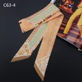 Dettaglio foulard Twilly effetto seta con motivi floreali e geometrici arancioni - C63-4