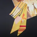Detailed shot of yellow leaf pattern silk scarf with geometric prints on a magazine - Yellow Surfboard Pattern(T360-1)