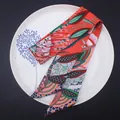 Detail of bohemian floral print silk twilly scarf showing smooth texture and vibrant colors - Orange Red Contrast (C108-4)