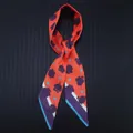 Orange silk-like twilly scarf with purple leaf patterns and striped edges for bags or hair - Orange Red