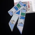 Detail of silk twilly scarf with equestrian motifs and geometric blue and green patterns - Sky Blue Patchwork (C137-1)