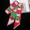 Detail of multi-color horse harness print twilly scarf on fashion magazine - Red Green Pink Patchwork (C137-2)