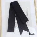 Detail of a 200cm black satin ribbon scarf with elegant pointed ends and a care label - 200cm / Black