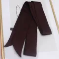Detail of coffee brown satin scarf showing smooth silk texture and fabric care label - 200cm / Coffee