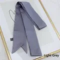 Detail of light gray satin skinny scarf showing smooth silk texture and slanted ends - 200cm / Light Gray