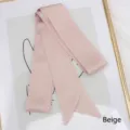 Detailed view of beige satin ribbon scarf with elegant glossy finish and diagonal ends - 200cm / Off White
