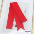 Detail of a magenta satin long scarf with a smooth finish and black care label detail - 200cm / Red