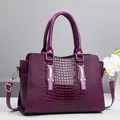 Borsa a mano viola in pelle verniciata con motivo a coccodrillo e dettagli dorati - Viola