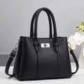 Classic black lychee pattern leather handbag with silver lock and detachable shoulder strap - Black