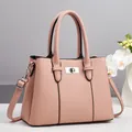 Pale pink lychee grain leather handbag with silver lock and shoulder strap - Pink