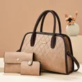 Detailed macro of the brown quilted leather tote with elegant gold metal trim and stitching - Khaki