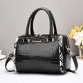 Sac à main noir brillant effet crocodile avec détails serpent et finitions dorées - Noir