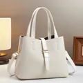 Detail of cream white bucket bag with woven texture and premium gold metal hardware - Off White