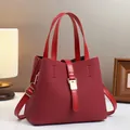 Close-up of luxury red bucket bag with woven texture and premium gold metal hardware - Red