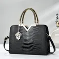 Elegant black crocodile pattern handbag with gold V hardware and woven handle - Black