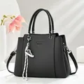Elegant black textured crossbody handbag for women featuring a stylish sneaker charm - Black
