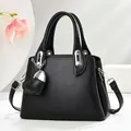 Elegant black pebble leather bucket bag with top handles and silver hardware - Black