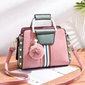 Pink and green contrast handbag with pearl studs, fur pompom, and metal handle - Pink
