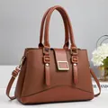 Classic brown pebble leather handbag for women with dual handles and gold hardware - Earthy Yellow