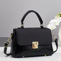 Black mixed-texture handbag with gold clasp, top handle, and detachable strap for women - Black
