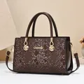 Dunkelbraune Handtasche mit Krokoprägung, goldenen Muschelelementen und Umhängeriemen - Kaffeebraun