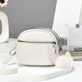 White lychee leather crossbody bag with three silver zippers and white fluffy ball keychain - 19x15x7 / Off White