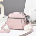 Pink textured leather crossbody bag with triple zippers and plush pompom charm - 19x15x7 / Purple