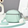Mint green lychee texture crossbody bag with triple zippers and plush ball charm - 19x15x7 / Dark Green