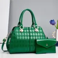 Detail of green patent leather tote and envelope clutch with gold metal hardware - Green