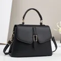Classic black litchi texture top-handle bag with gold hardware and crossbody strap - Black