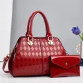 Detalle del conjunto de bolso rojo de charol acolchado con sobre de mano a juego y herrajes - Rojo