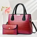 Detail view of rainbow crocodile pattern tote bag set with matching wallet and gold hardware - Rose Red