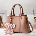 Dusty pink litchi leather handbag for women with bow accessory and gold hardware - Pink