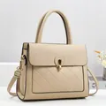 Elegant beige quilted leather handbag with metal ring lock and adjustable shoulder strap - Khaki