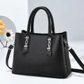 Minimalist black leather handbag for women with silver chain detail and shoulder strap - Black