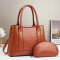Detail of tan faux leather tote bag set with detachable strap and small clutch bag - Earthy Yellow