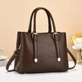 Close-up of brown striped bucket bag featuring golden hardware and leather tassels - L28 W13 H20 / Coffee