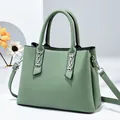 Structured sage green crossbody bag with dual handles and silver chain detail - Fruit Green